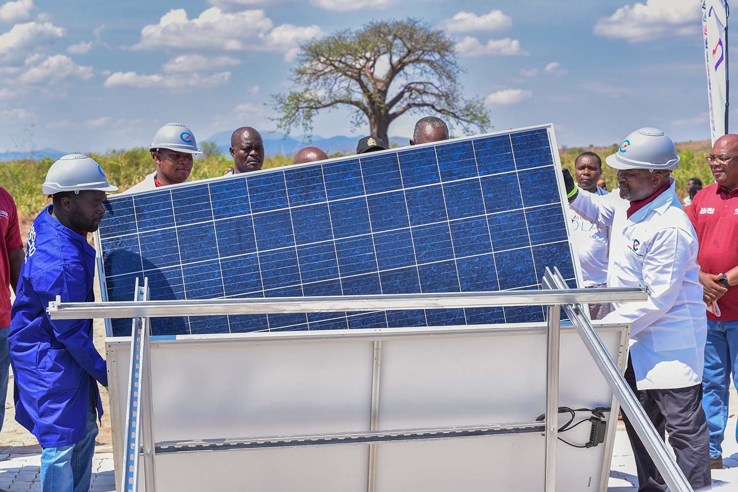 Minister Matola symbolically installs a solar panel